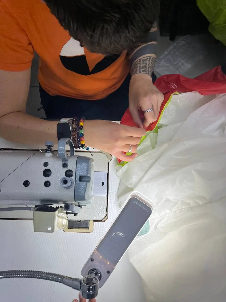 Skye practicing replacing a panel on a top surface of a paraglider